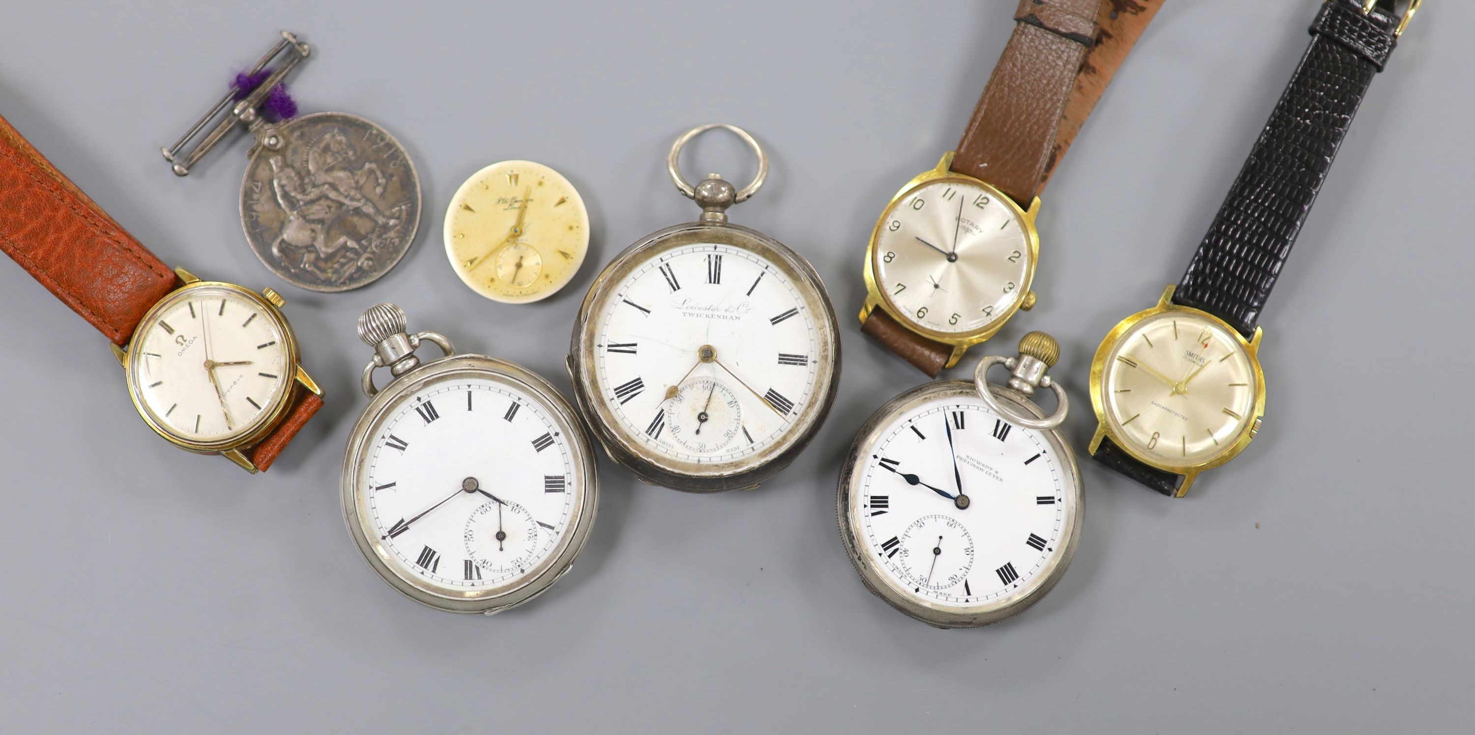 A gentleman's steel and gold plated Omega manual wind wrist watch, three other wrist watches, three pocket watches and a medal.